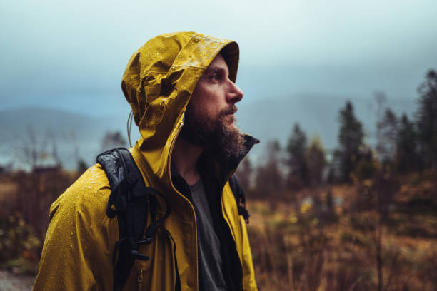 istock Man outdoors in winter rain in Norway with waterproof jacket 2184508090