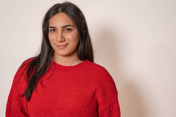 istock Woman in a Bright Red Sweater Smiling 2184509660