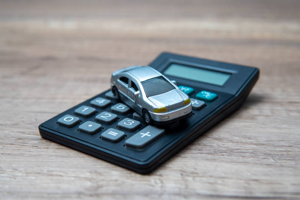 A toy car on top of a calculator.