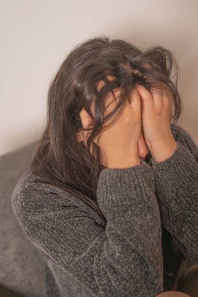 istock Person Covering Face in Thoughtful Moment 2184510035