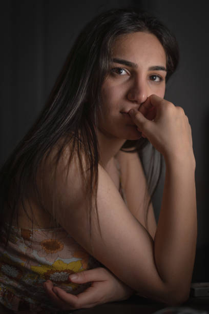 istock Thoughtful Woman in Soft Light 2184510278