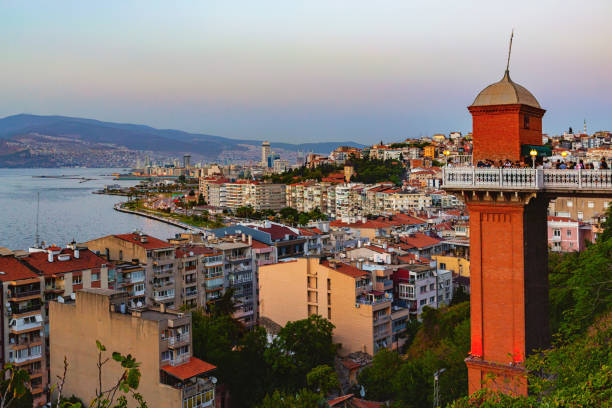 istock Panoramic view of Izmir city. Historic elevator tower in foreground, skyline and coastal landscape at sunset. Turkey (Turkiye) 2184510621