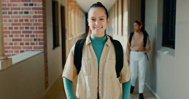 istock Happy, hallway and portrait of student at school with backpack for learning, studying or knowledge. Smile, teenager and girl in corridor of academy for education class with scholarship. 2184510735
