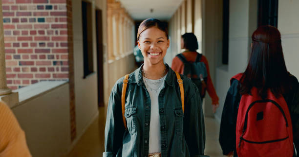 istock Happy, corridor and portrait of student at school with backpack for learning, studying or knowledge. Smile, teenager and girl in hallway of academy for education class with scholarship. 2184510739