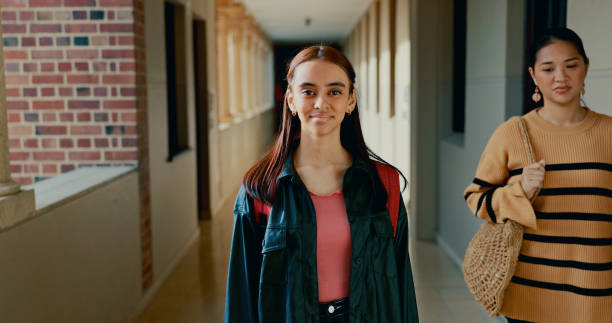 istock School, hallway and portrait of student at academy with backpack for learning, studying or knowledge. Smile, teenager and happy girl in corridor for education class with scholarship. 2184510747