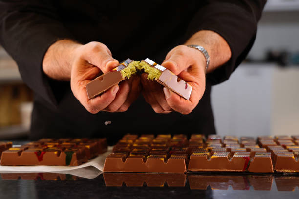 male chef shows off his newly prepared dubai chocolate - schokolade stock-fotos und bilder