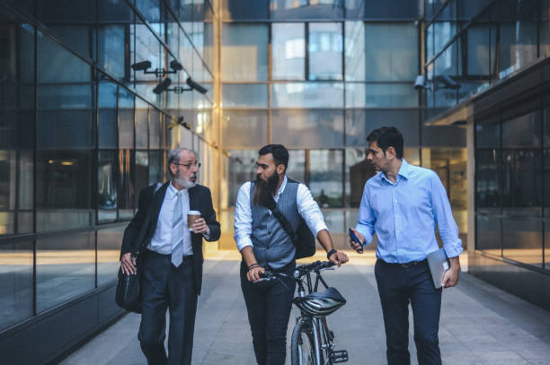 istock Business Professionals Discussing Walking Outside Office Building 2184512888
