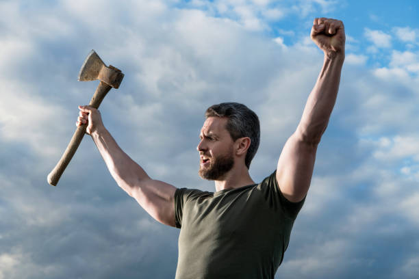 Close-up of a lumberjack cutting wood at farm