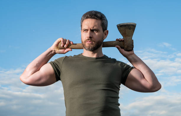 istock confident man with axe. woodman man hold ax. brutal man on sky background 2184513558