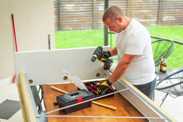istock Handyman using cordless drill assembling furniture parts at home 2184515291