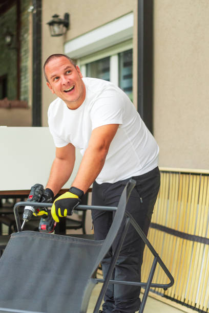 istock Happy handyman assembling furniture using cordless drill at home 2184515293