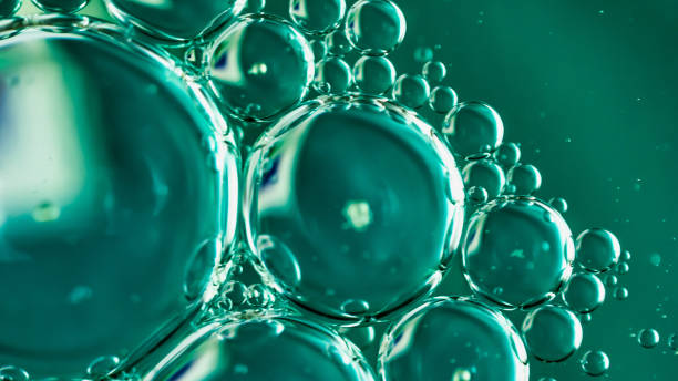 istock oil drops on water on blue background 2184515444