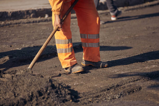 istock Construction workers working on a new asphalt layer on a public street. 2184515865