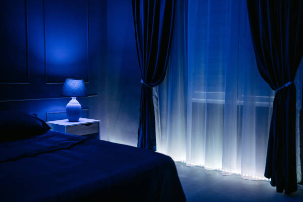 istock An Empty Bedroom With A Queen Size Bed Under Blue Neon Lights At Night 2184516538