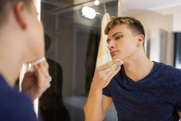 istock Young Man Practicing Daily Grooming Routine in the Bathroom Mirror 2184518064