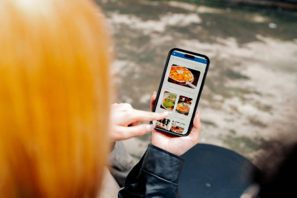 istock Couple Browsing Food Options on Mobile App for Quick and Convenient Ordering 2184518473