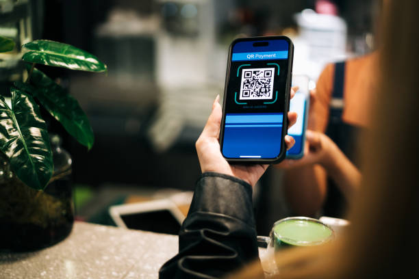 Close-up of a customer using QR code for a cashless payment at a cafe, showcasing modern technology and convenience. Ideal for themes of digital transactions and contactless service.