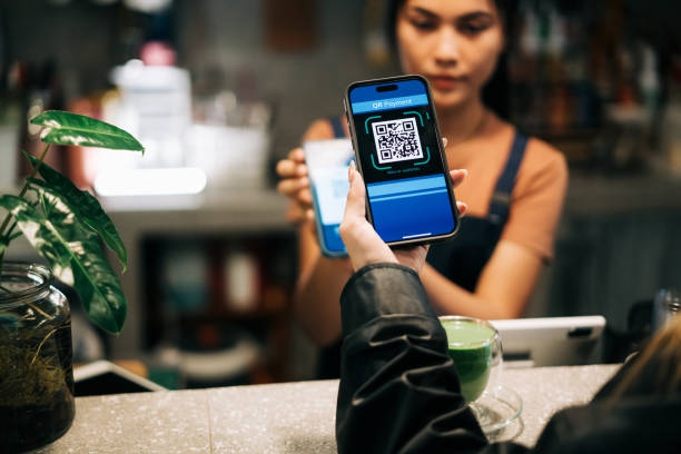 istock Cashless Transaction at Coffee Shop Using QR Code on Smartphones 2184518644