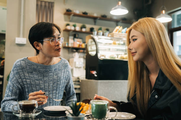 istock Friends Enjoying Coffee and Conversation at Cozy Cafe 2184518648