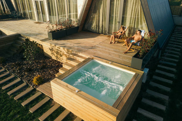 istock Couple sunbathing in front of an A-frame house 2184518732