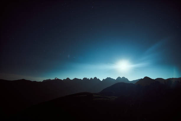 istock Moonlight illuminates mountain silhouettes under a starry night sky in a remote location 2184519081