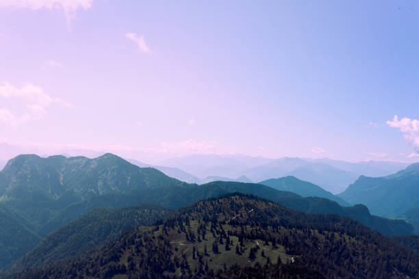 istock Majestic mountain landscape showcasing rolling hills and distant peaks under a clear blue sky at sunrise 2184521587