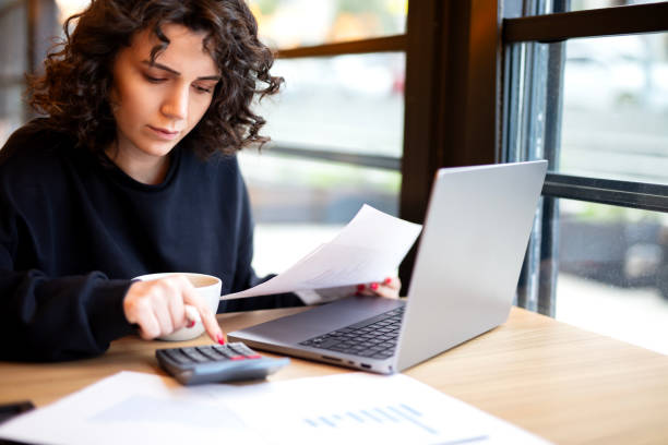 istock Close up Business woman using calculator and laptop 2184521864
