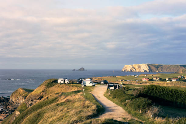 istock Scenic coastal view with camper vans overlooking the ocean and cliffs at sunset 2184522129
