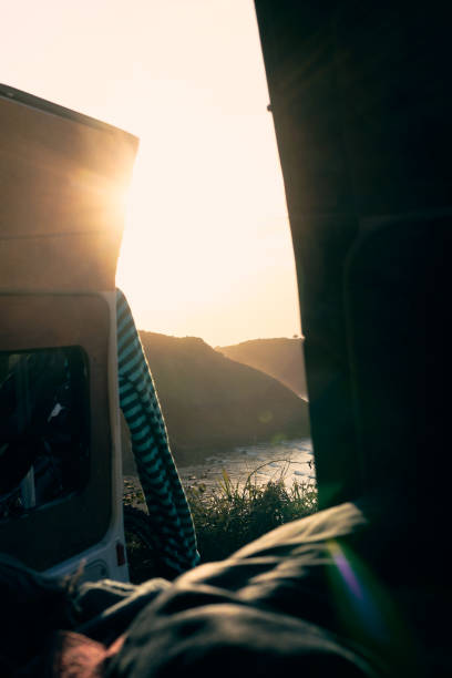 istock Sunset view from a camper by the river with mountains in the background 2184522156