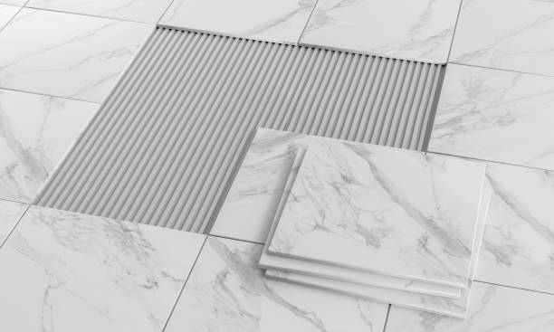 Marble effect floor tiles being laid using pre-formed ceramic tile adhesive ridges