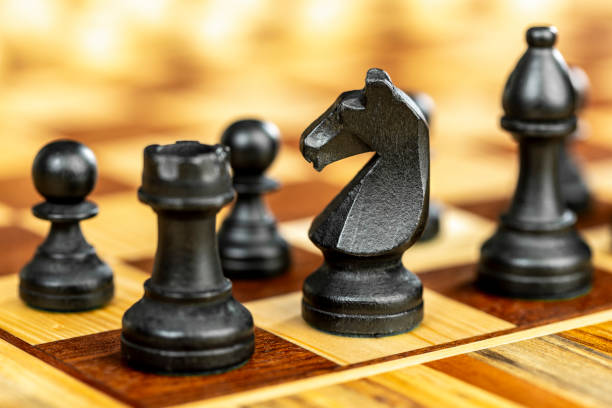 istock black knight chess piece on a wooden chessboard 2184523874