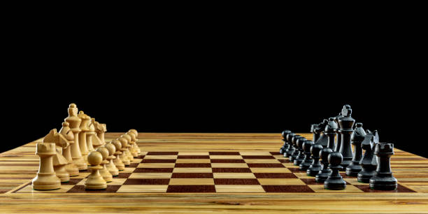 istock Wooden chess pieces standing on chessboard 2184523922