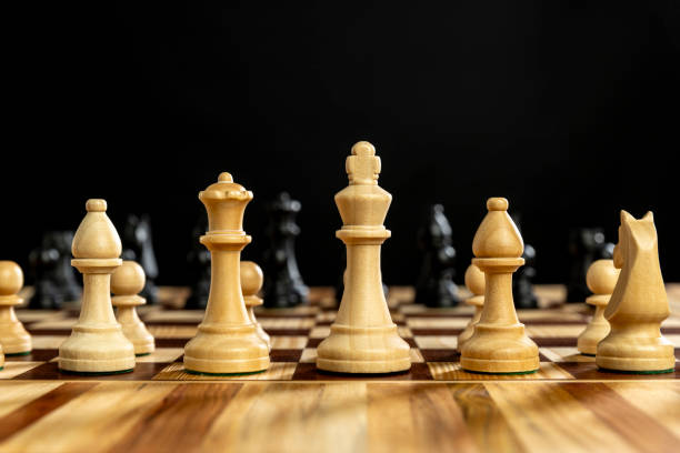 istock Chess pieces on wooden chessboard 2184523944