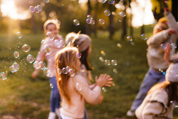 istock Soap bubbles and children in the background 2184524214