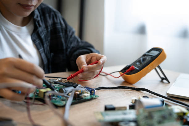 istock A person is working on a circuit board with a multimeter. The person is focused and determined to fix the problem 2184524373