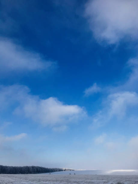istock Winter landscape with blue sky and snow-covered fields 2184525246