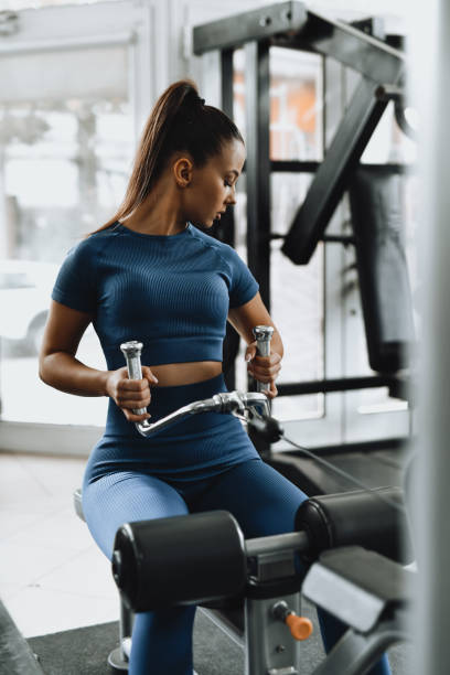 istock Fit Strong Female Working Out Back Doing Seated Cable Rows in Gym 2184526849