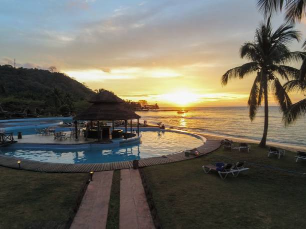 istock View from a pool with sunset reflecting in the sea. 2184527251