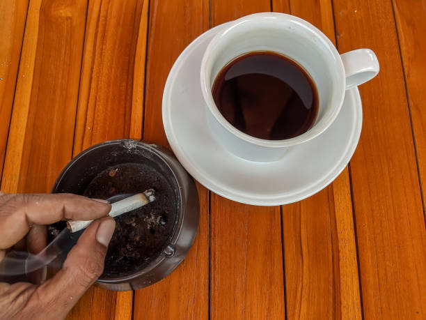 istock This image features a cigarette poised in an ashtray next to a steaming cup of coffee 2184527496