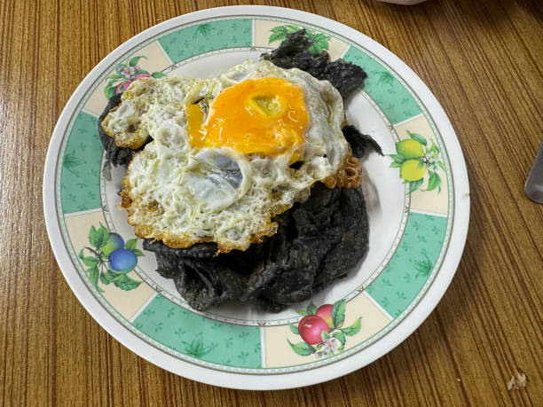 istock Charcoal Roti topped with Fried Egg in Phuket, Thailand. 2184527848