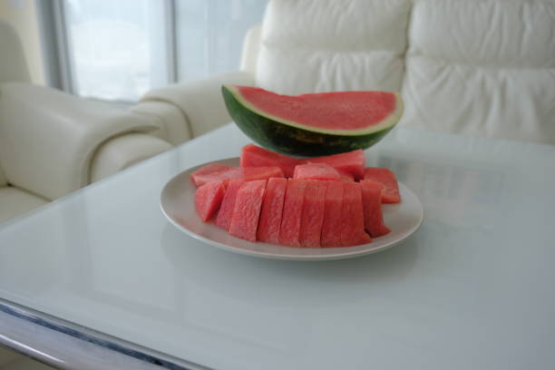 ripe red watermelon on white background. red watermelon on a white plate and white table