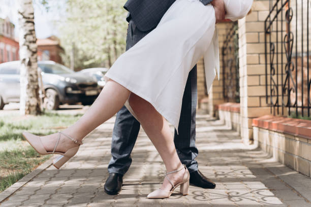 istock bride and groom dancing in street 2184530363