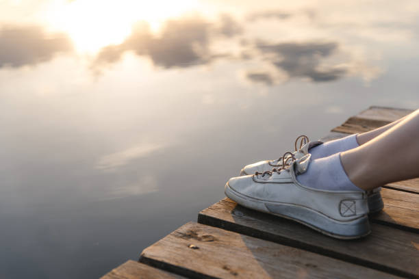 istock young woman sits at pier 2184530402