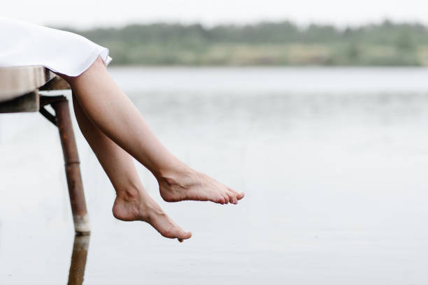 istock young woman sits at pier 2184530468