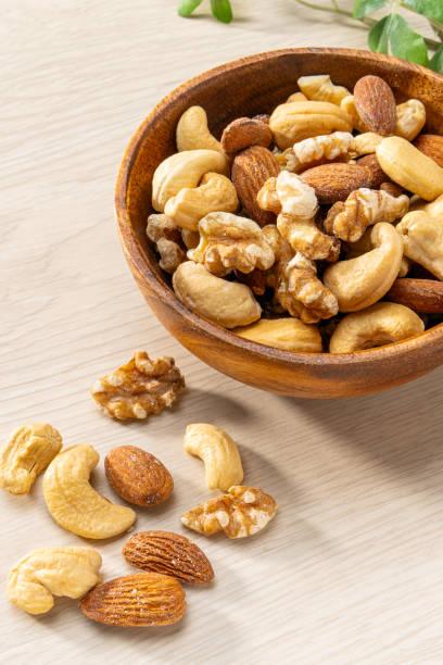 istock Assortment of nuts in wooden bowl 2184533677