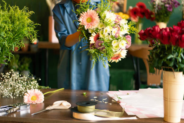 istock Woman's hand preparing bouquet in flower shop 2184535809