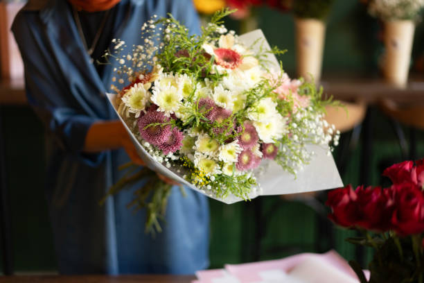 istock Woman's hand preparing bouquet in flower shop 2184536073