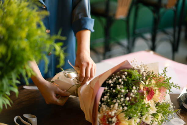 istock Woman's hand preparing bouquet in flower shop 2184536322