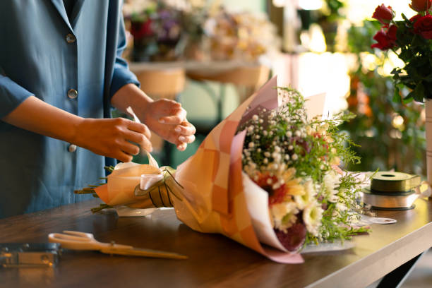 istock Woman's hand preparing bouquet in flower shop 2184536466