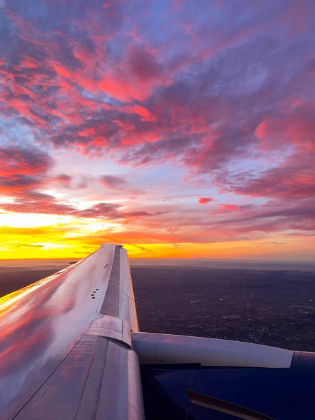 Sunrise over the horizon seen through the window of a holiday jet, Travel concept.